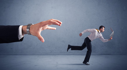 Businessman running from hand