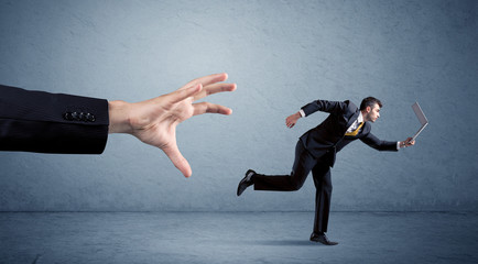 Businessman running from hand