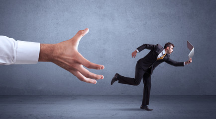 Businessman running from hand