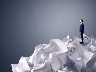 Businessman standing on crumpled paper