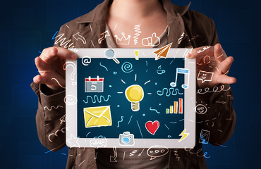 Woman holding tablet with applications