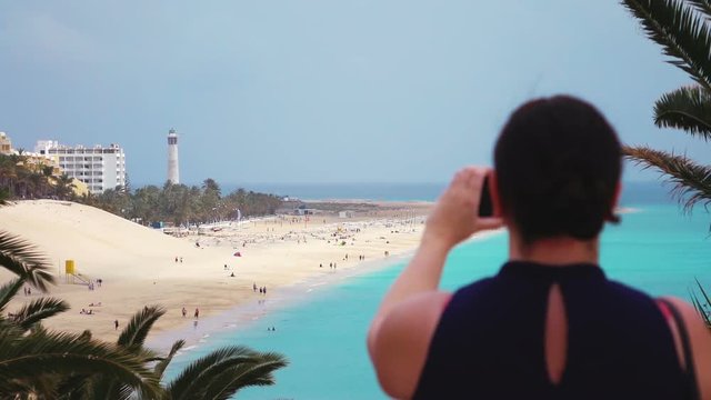 High quality video of woman taking a picture on the vacations on canary islands in real 1080p slow motion 120fps