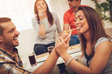 Young Couple Eating Pizza
