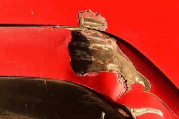 scratch on surface red door of truck