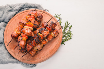 Marinated baked kebab with onions and spices. On a wooden background. Top view. Free space for text.