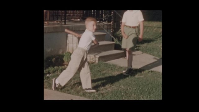 50's father and son play baseball