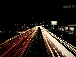 Fototapeta na wymiar Speed traffic - light trails on motorway highway at night, long exposure abstract urban background.