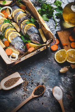 Salmon on rustic table with fresh ingredients for cooking