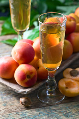 Juicy apricots with leaves and sweet wine .