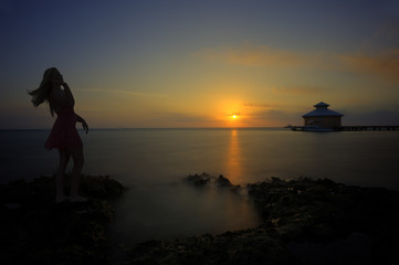 Woman up at sunrise on beach