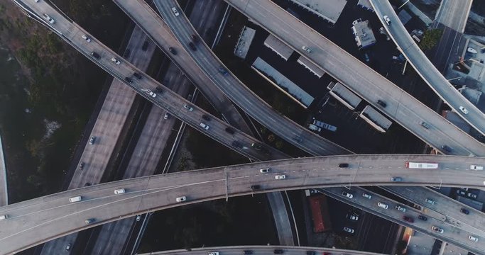 Aerial view looking straight down above busy freeway interchange with traffic 