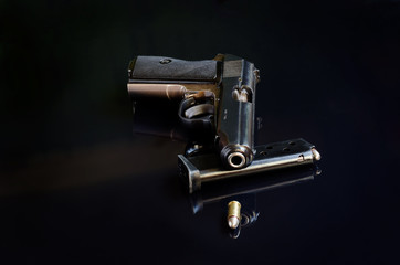 Fototapeta premium Handgun on black reflective background