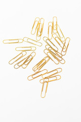 Stationery vertical. Golden paper clips on paper on white background