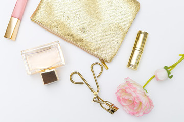 Cosmetics and accessories pink&gold on a white background. Lifestyle flat lay