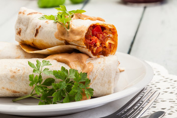 Mexican burritos wraps with mincemeat, beans and vegetables
