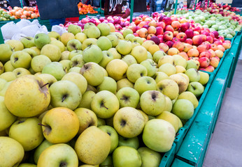 Apples on the market, a large fruit counter, ripe apples red, green