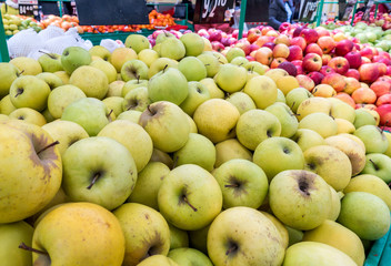 Apples on the market, a large fruit counter, ripe apples red, green