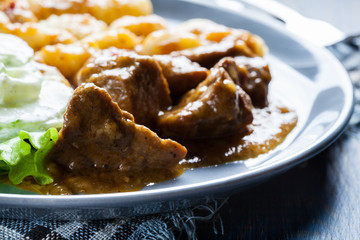 Italian potato dumplings with stew and cucumber salad