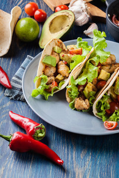 Authentic mexican tacos with chicken and salsa with avocado, tom