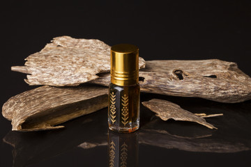 Agarwood, also called aloeswood, essential oil and incense chips