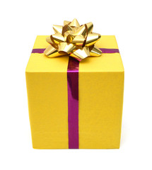 gift yellow box with gold ribbon bow close up isolated on white background
