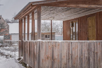 unfinished country house in winter. Closeup of wooden terrace