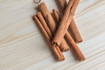 cinnamon sticks on wooden table.