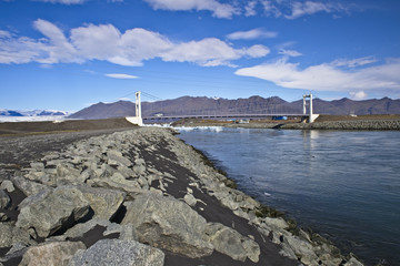 Bridge over the river flowing out of the Icelberg Lagoon, meltwater from the glacier, Iceland.
