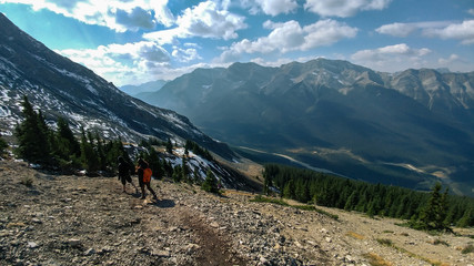 Fototapeta na wymiar Hikers on Ha Link Peak's way down, with Canadian Rocky Mountains on background