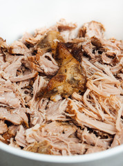 Traditional American Slow cooked Pulled pork made of boneless shoulder roast shredded with two forks cooked in crockpot or on bbq grill for Mexican Pork Carnitas, taco, tortillas or barbecue party