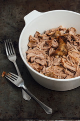 Traditional American Slow cooked Pulled pork made of boneless shoulder roast shredded with two forks cooked in crockpot or on bbq grill for Mexican Pork Carnitas, taco, tortillas or barbecue party