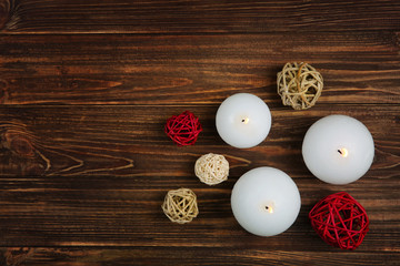 Composition with burning candles on wooden background, top view