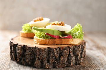 Delicious sandwich on wooden serving board, closeup