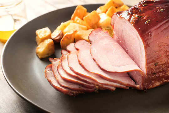Traditional sliced honey baked ham on plate, closeup