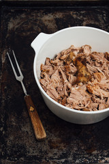 Traditional American Slow cooked Pulled pork made of boneless shoulder roast shredded with two forks cooked in crockpot or on bbq grill for Mexican Pork Carnitas, taco, tortillas or barbecue party