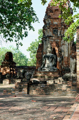 The buddha statue in meditation posture with the sunlight emitting from the sky to illustrate a look of wise, calm, discreetly and respectful of his enlightenment.