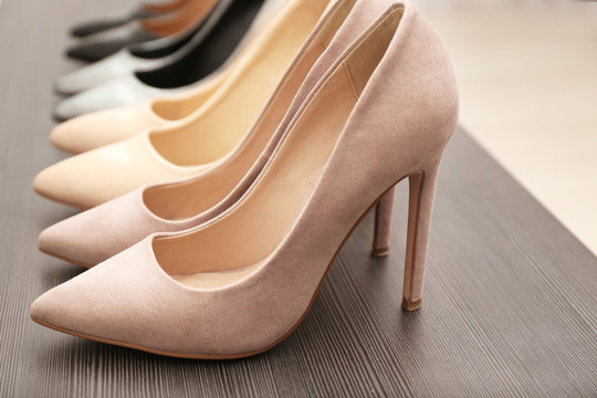 Elegant Beige Shoes On Wooden Shelf, Closeup