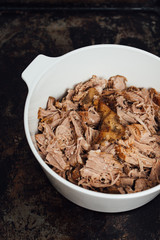 Traditional American Slow cooked Pulled pork made of boneless shoulder roast shredded with two forks cooked in crockpot or on bbq grill for Mexican Pork Carnitas, taco, tortillas or barbecue party