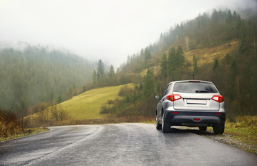 Car on country road in rainy weather