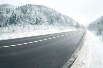 Country road in snowy winter day