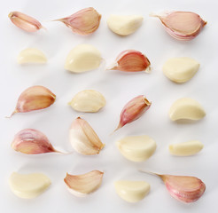 Composition with garlic cloves on white background