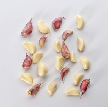 Garlic cloves on white background