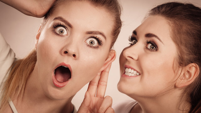 Two women telling gossip