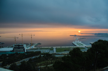 Sunset .The sun goes out on the edge of the Caspian Sea . Amazing view of clear sea landscape with cloudy sky as a background Sunset time. Baku, Azerbaijan