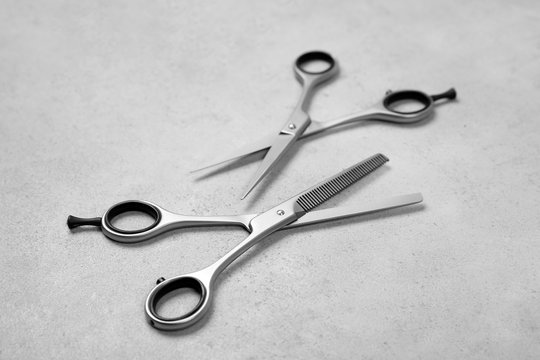 Professional hairdresser scissors on grey background