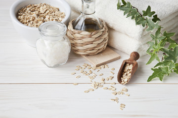 Ingredients for aromatherapy and spa treatments, aromatic sea salt and towels. Spa kit for beauty and health on a white wooden background. Close up, selective focus, shallow depth of field