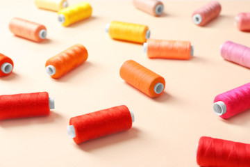 Set of sewing threads on color background