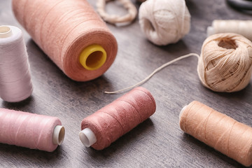 Sewing threads with clews on grey background