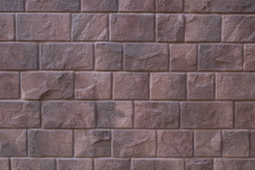 red stone wall background, Large stone-clad facade brown color.