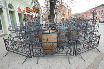 The restaurant is closed on the street of the city. The iron fence isolates the restaurant area. Chairs and tables are complex disorderly. In the winter the ambience of the restaurant is sad.  